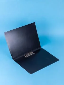 Black plastic folder  for documents isolated on blue  background Stock Photos