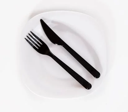 Black plastic fork and knife isolated on white background Stock Photos