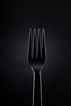 Black Plastic Fork on Dark Background Stock Photos