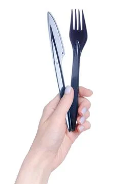 Black plastic fork, knife in hand Stock Photos