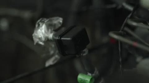 Black plastic fuel check valve with tubes in engine bay Stock Footage 340272924