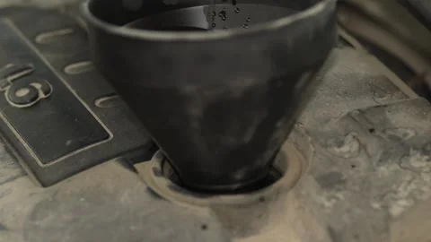 Black plastic funnel inserted into car engine oil filler neck. Stock Footage 341487678
