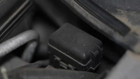 Black plastic fuse box cover located in car engine bay. Stock Footage 344365763