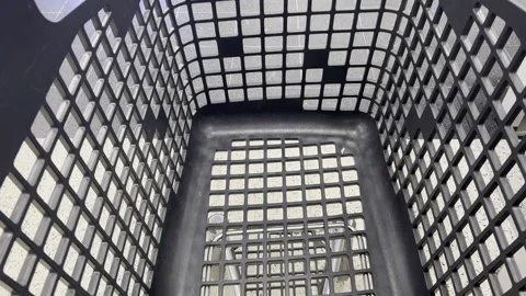 Black plastic laundry basket with grid pattern viewed from above in sequence Stock Footage 338262080