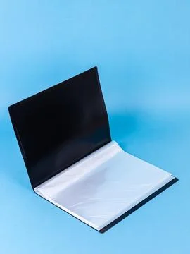 Black  plastic office folder on blue background. Office Folder Template Stock Photos