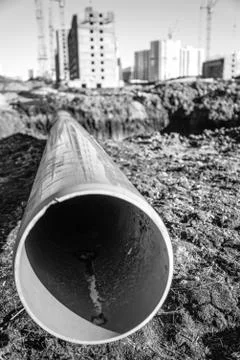 Black Plastic pipe of large diameter on black land closeup Foto stock