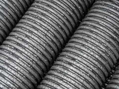 Black plastic pipes of various diameters in a row Stock-Fotos