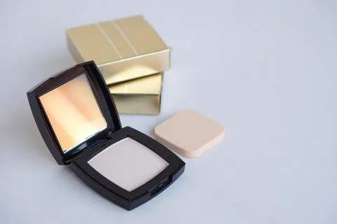 Black plastic powder compact case with a mirror. Cosmetic face powder Stock Photos