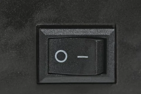 Black plastic power on and off button. Stock Photos
