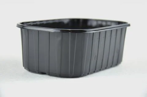 Black plastic PP5 container isolated on a white background, side view Stock Photos