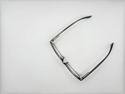 Black plastic reading glasses open center top view on white background Stock Photos