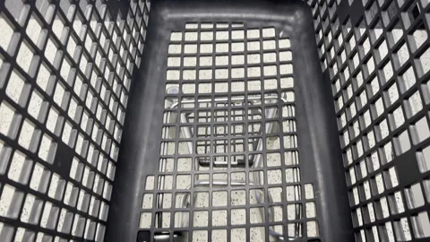 Black plastic shopping basket viewed from above, showing grid pattern, interior Vídeos de archivo 344751272