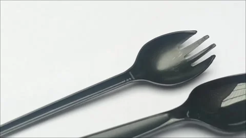 Black Plastic Spoon and Fork on White Background Closeup Stock Footage 335191657