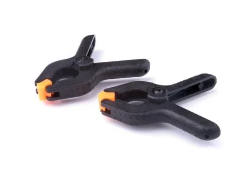 Black plastic spring clamp isolated on white background. Stock Photos