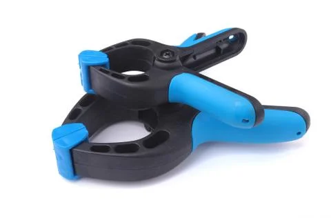 Black plastic spring clamp isolated on white background. Stock Photos