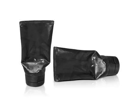 Black plastic squeezed tube. Packaging for cosmetics on a white background Foto stock
