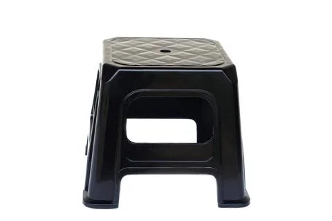 A black plastic stool with a simple and durable design, isolated on white backgr Stock Photos