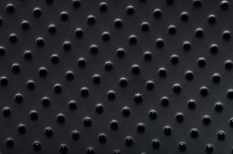 Black plastic surface with dots Stock Photos