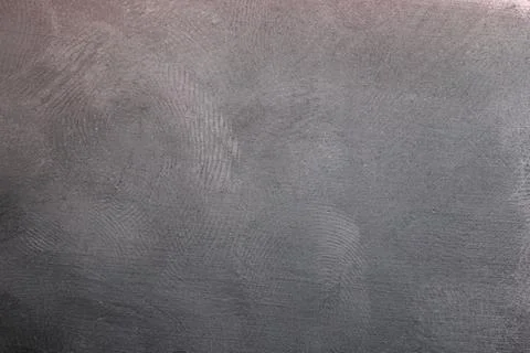 Black plastic surface with multiple fingerprints, macro photo Stock Photos