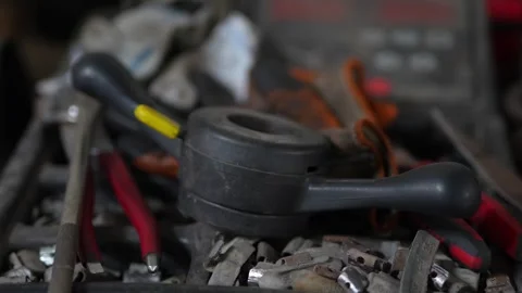Black plastic three pronged clamping knob surrounded by workshop tools. Stock-Footage 343891580