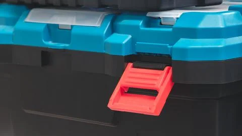 Black Plastic Tool Box with Blue Lid with Open Red Lock Stock Photos