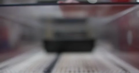 Black plastic tray moving through a packaging machine in a food production 動画素材 339975340