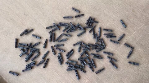 Black Plastic Wall Plugs Scattered on Ground for Construction and Fixing Use Видео 324792311