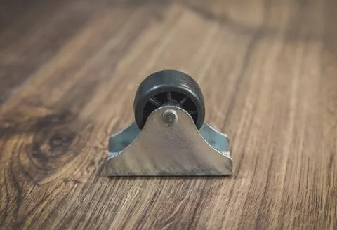 Black plastic wheel which will attached to the furniture Stock Photos