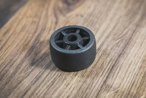 Black plastic wheel which will attached to the furniture Stock Photos