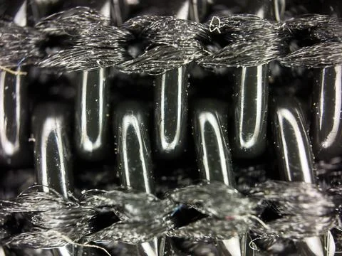 Black plastic zipper under a microscope, macro shot of lightning Fotos de archivo