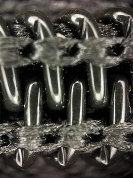 Black plastic zipper under a microscope, macro shot of lightning Stock Photos