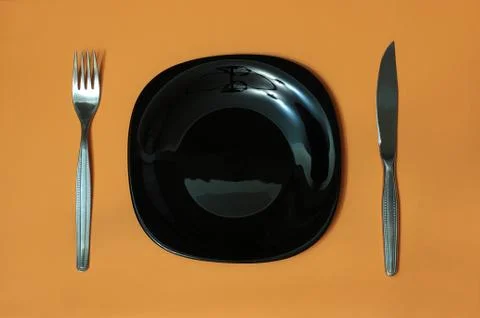 Black plate, fork, knife Stock Photos