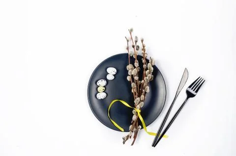 Black plate with willow twigs, Easter table setting Stock Photos