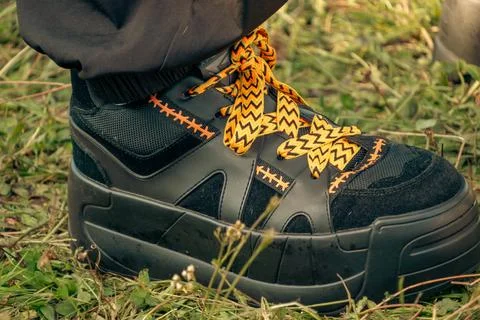 Black Platform Chunky Boot With Yellow Patterned Shoelaces Stock Photos