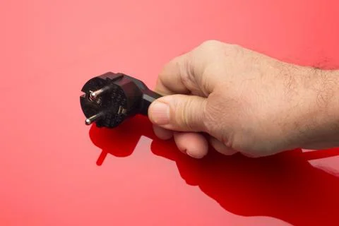 Black plug on colored background Stock Photos