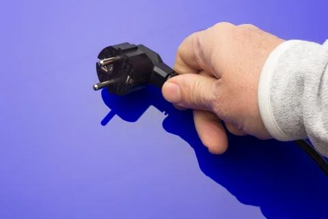 Black plug on colored background Stock Photos