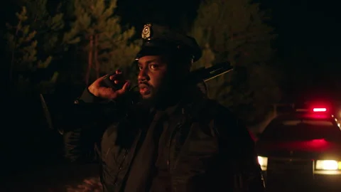 Black policeman with a shotgun Stock Footage 283104632