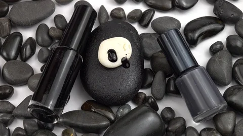 Black polish on black pebbles Video stock 128175190