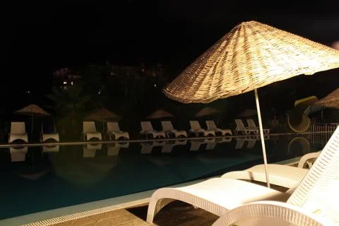 A black poolside at night Foto stock