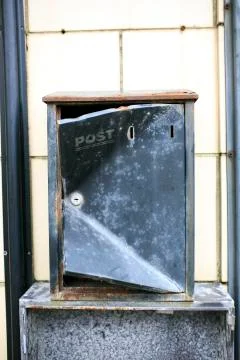 Black postbox in a white wall Stock Photos