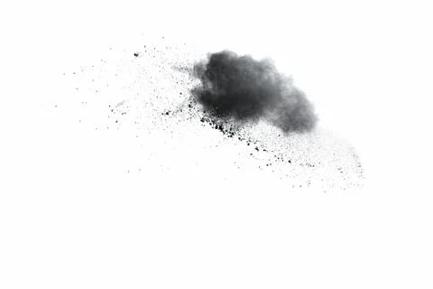 Black powder explosion on white background. Abstract black dust splattered. Stock Photos