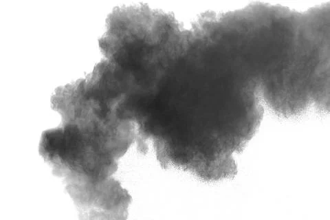 Black powder explosion on white background. Abstract black dust splattered. Stock Photos