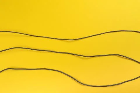 Black power cable set socket on yellow background -  Image Stock Photos