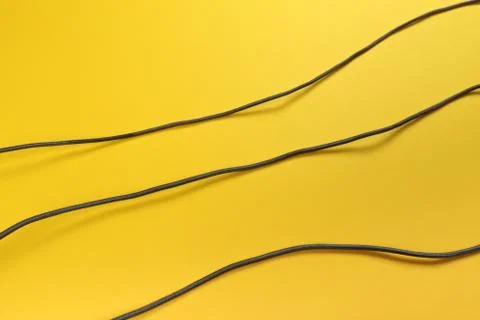 Black power cable set socket on yellow background -  Image Stock Photos
