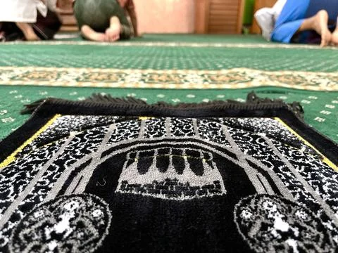 Black prayer mat inside a mosque Stock Photos