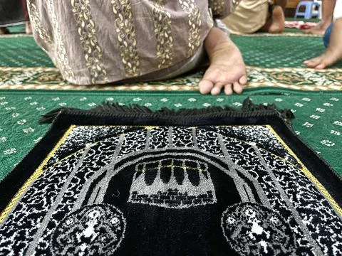 Black prayer mat inside a mosque Stock Photos
