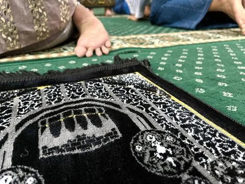 Black prayer mat inside a mosque Stock Photos