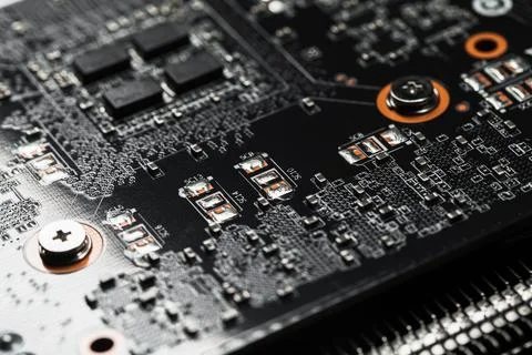 Black printed circuit board with microchips and capacitors Stock Photos