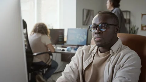 Black Professional Working on Desktop Computer in Modern Office Stock Footage 348144202