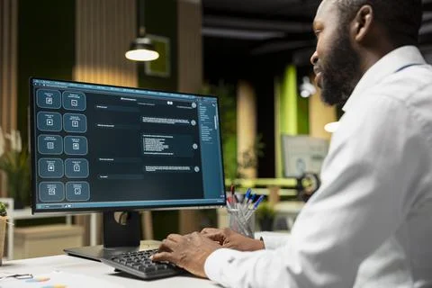 Black programmer developing an app and software algorithm on pc Stock Photos